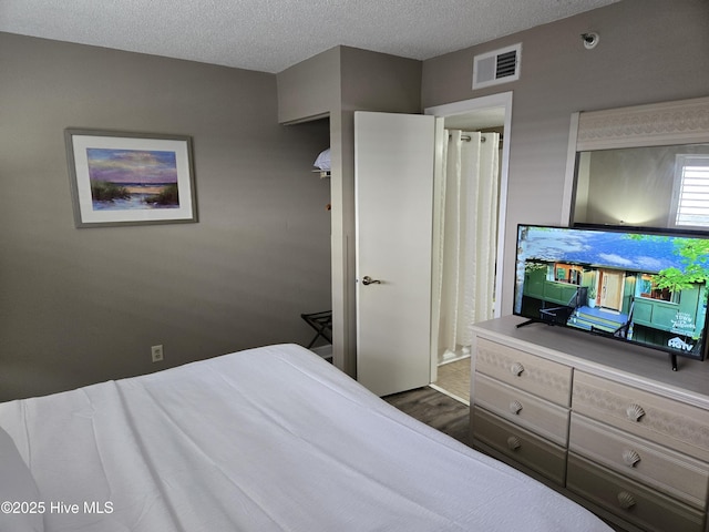 bedroom with visible vents and a textured ceiling