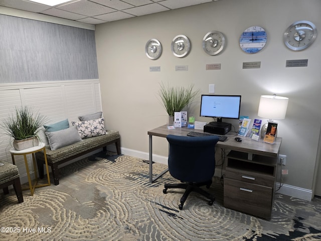 office area with a drop ceiling and baseboards