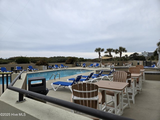 pool with fence and a patio area