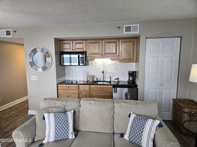 kitchen with a sink, visible vents, dishwasher, and stainless steel microwave