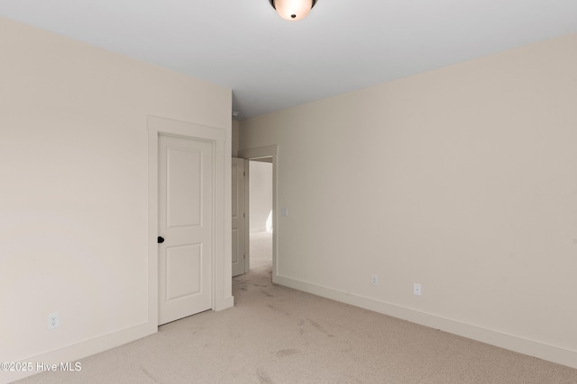 unfurnished bedroom with baseboards and light colored carpet