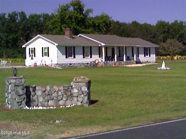 ranch-style house featuring crawl space, a chimney, and a front yard