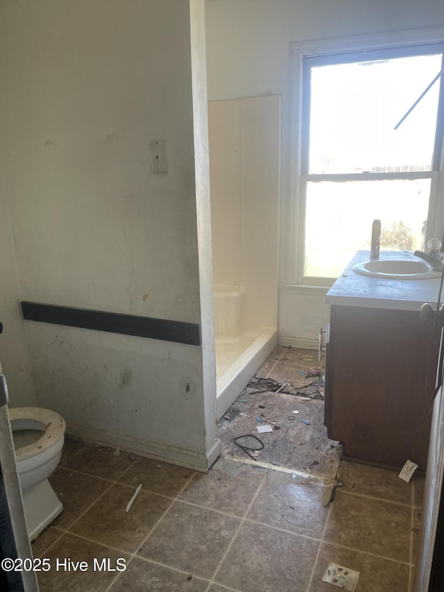 full bath with toilet, a stall shower, and vanity