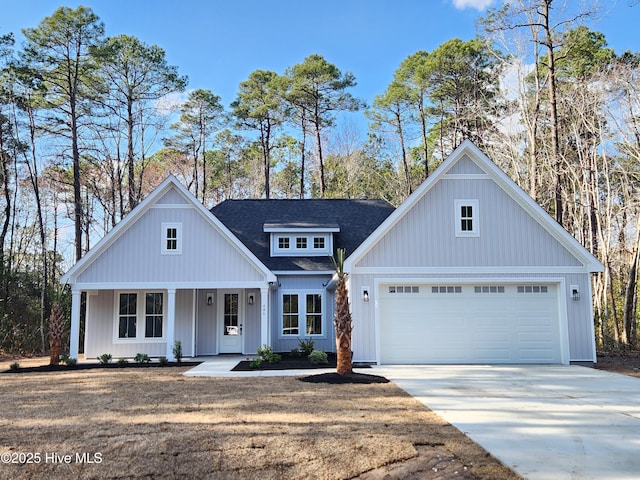 modern inspired farmhouse with concrete driveway, an attached garage, and a shingled roof