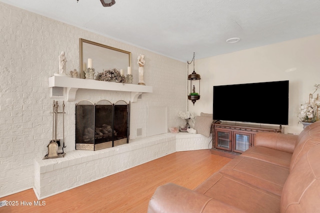 unfurnished living room featuring a fireplace, wood finished floors, and visible vents