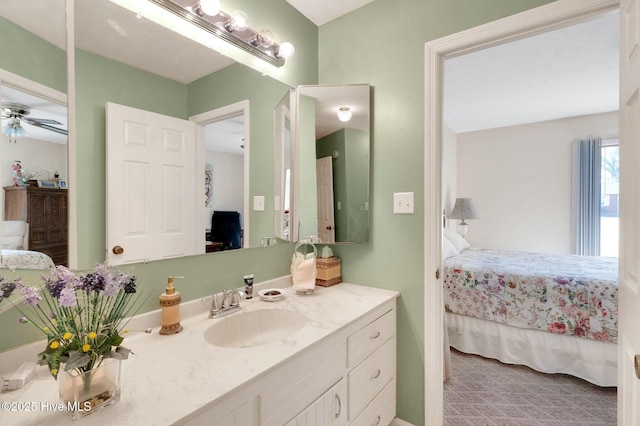 ensuite bathroom featuring connected bathroom, vanity, and a ceiling fan