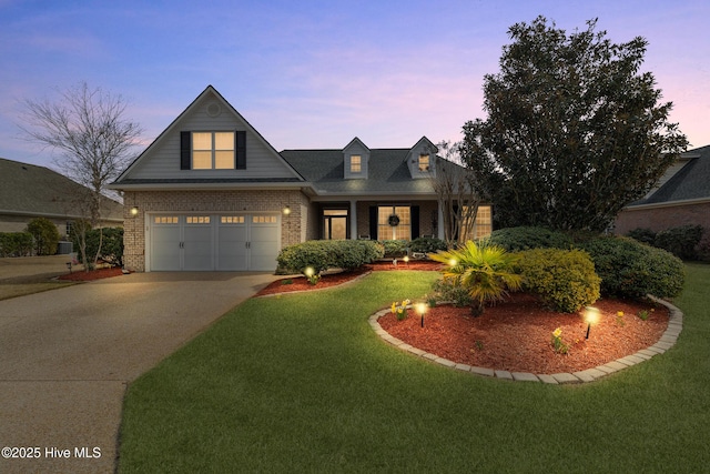 view of front facade featuring a front lawn, concrete driveway, and brick siding