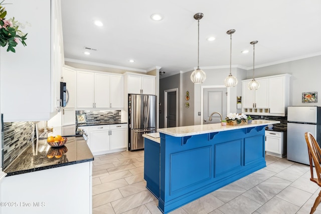 kitchen with stainless steel appliances, a kitchen breakfast bar, and white cabinetry