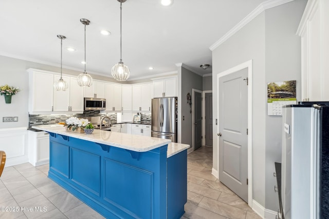 kitchen featuring a breakfast bar, white cabinetry, appliances with stainless steel finishes, crown molding, and decorative backsplash