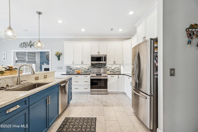 kitchen with appliances with stainless steel finishes, white cabinetry, blue cabinets, and a sink