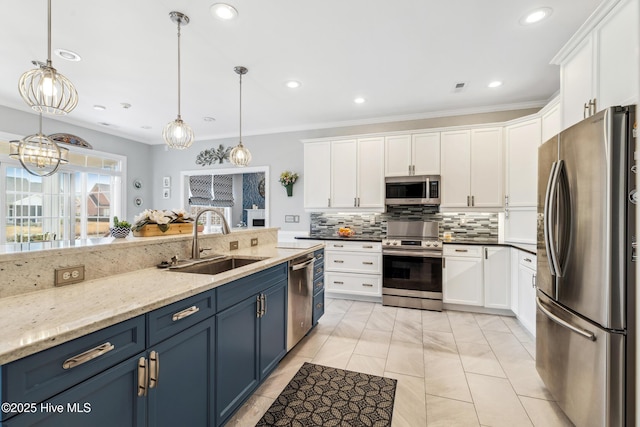 kitchen featuring blue cabinetry, white cabinets, appliances with stainless steel finishes, and a sink