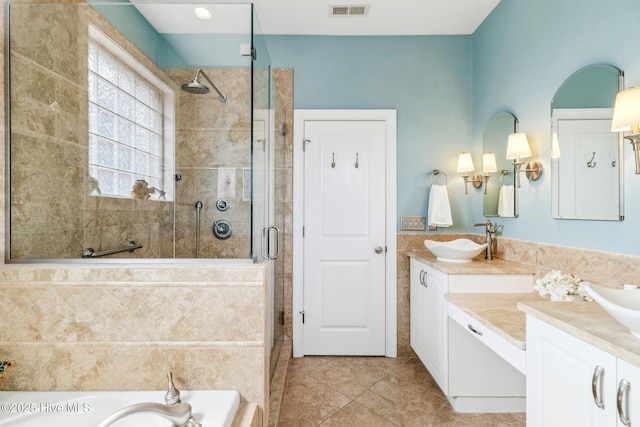 full bath with a sink, visible vents, a garden tub, and a stall shower