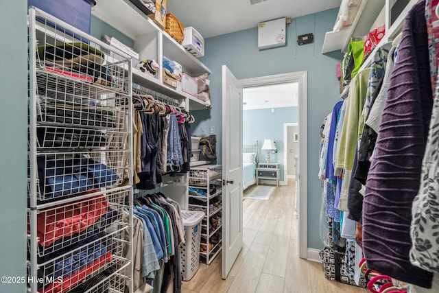 walk in closet featuring wood finished floors