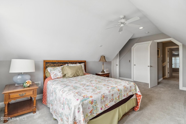 bedroom with light colored carpet, baseboards, lofted ceiling, and a ceiling fan