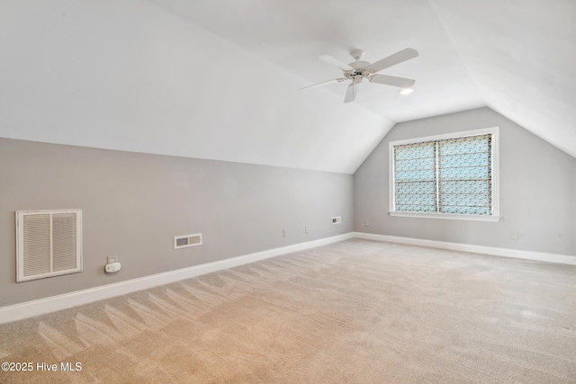 bonus room with lofted ceiling, baseboards, visible vents, and light carpet