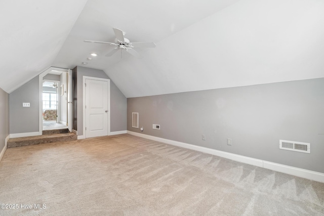 bonus room featuring baseboards, visible vents, ceiling fan, vaulted ceiling, and carpet flooring