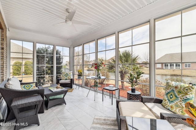 sunroom featuring a healthy amount of sunlight and ceiling fan