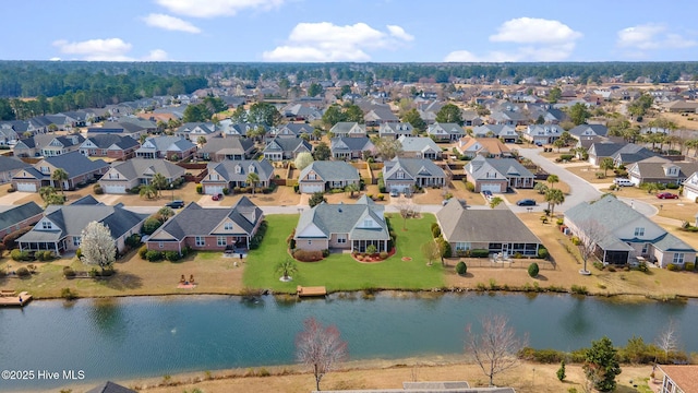 drone / aerial view featuring a residential view and a water view