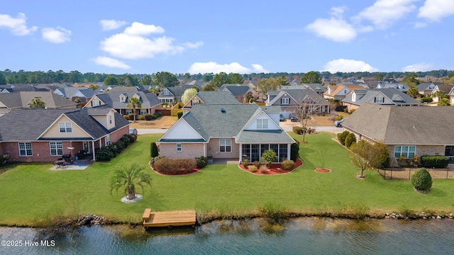 birds eye view of property with a residential view and a water view