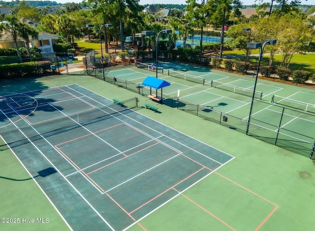 view of sport court featuring fence