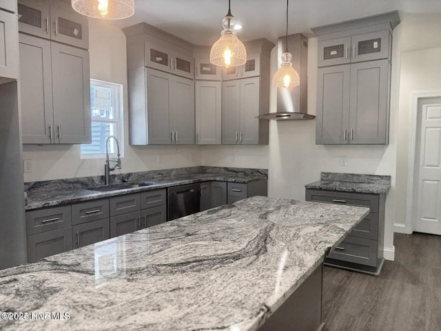 kitchen featuring light stone countertops, dishwasher, gray cabinets, wall chimney exhaust hood, and a sink