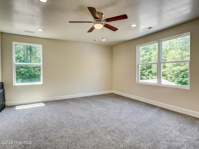 carpeted empty room featuring ceiling fan, recessed lighting, visible vents, and baseboards