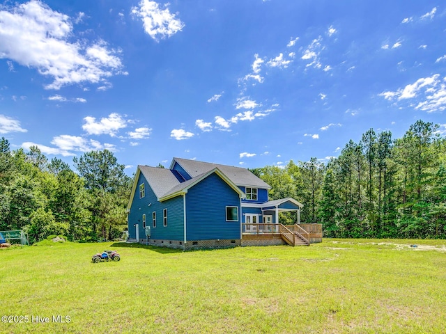 rear view of house with crawl space, a yard, and a deck