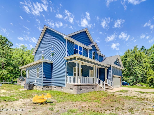 view of front of house featuring central air condition unit, a garage, covered porch, and crawl space