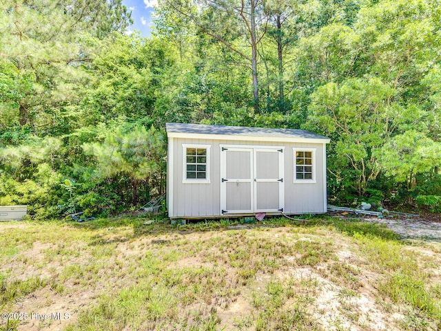 view of shed with a forest view