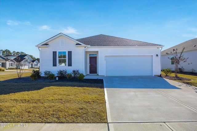 single story home featuring a front yard, an attached garage, concrete driveway, and roof with shingles