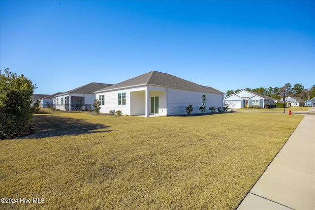 exterior space featuring a lawn and a garage