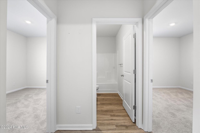 corridor with carpet and baseboards