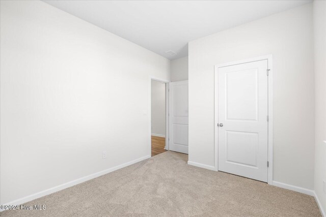 unfurnished bedroom featuring baseboards and carpet floors