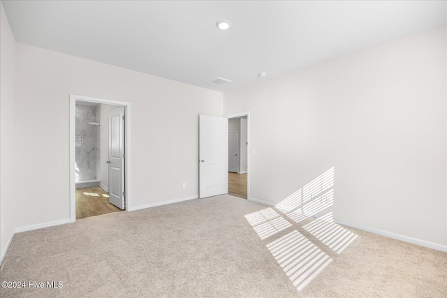 unfurnished bedroom featuring carpet flooring, visible vents, and baseboards