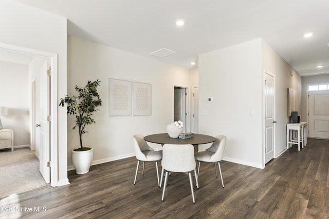 dining space with recessed lighting, baseboards, and wood finished floors