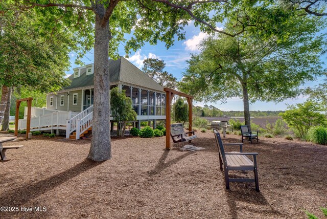 1808 Baywater Ct SE, Bolivia, NC 28422 - view of jungle gym with stairs and a sunroom