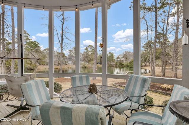 sunroom / solarium featuring a healthy amount of sunlight and a water view