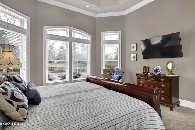 bedroom with visible vents, light colored carpet, crown molding, and baseboards