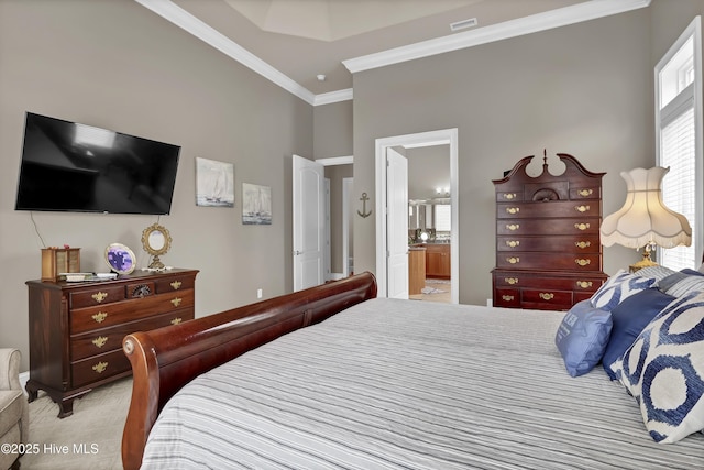 bedroom with ensuite bath and ornamental molding