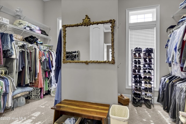 walk in closet with tile patterned floors