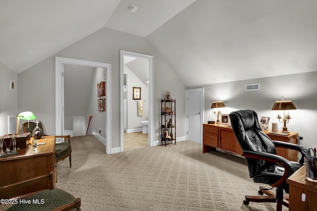 office space featuring light carpet, visible vents, baseboards, and vaulted ceiling