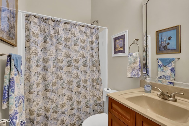 full bath with vanity, a shower with shower curtain, and toilet