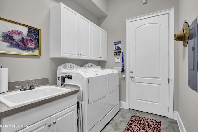 clothes washing area with light tile patterned floors, baseboards, cabinet space, a sink, and independent washer and dryer