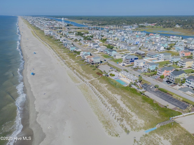 bird's eye view with a water view and a view of the beach