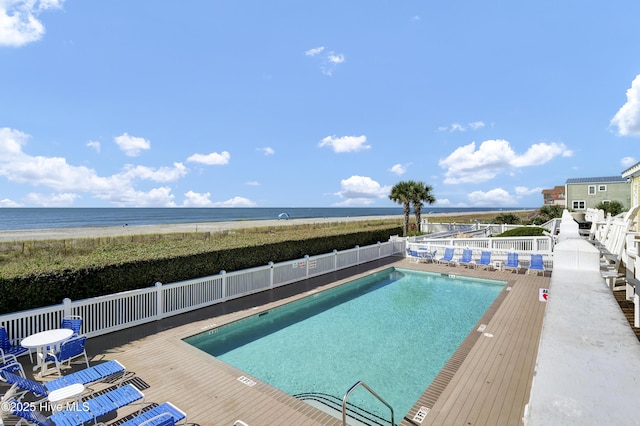 community pool featuring a deck with water view