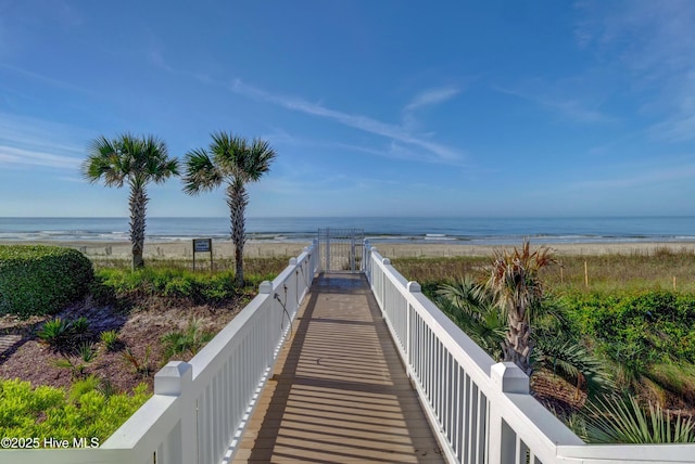 view of home's community featuring a water view and a beach view