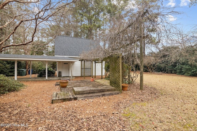 rear view of property with a shingled roof