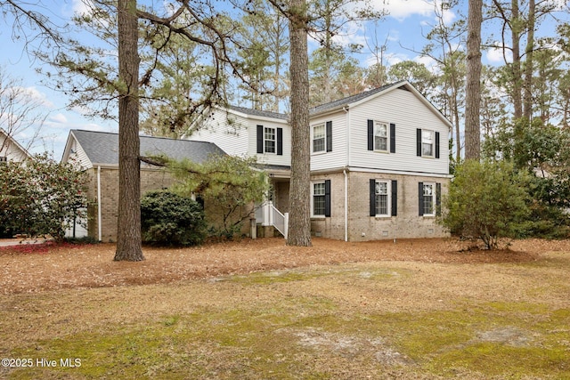 rear view of house featuring crawl space and brick siding