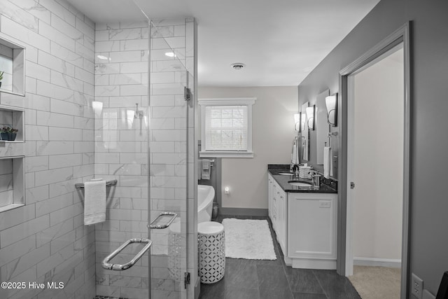 full bathroom featuring visible vents, a shower stall, baseboards, a freestanding bath, and vanity