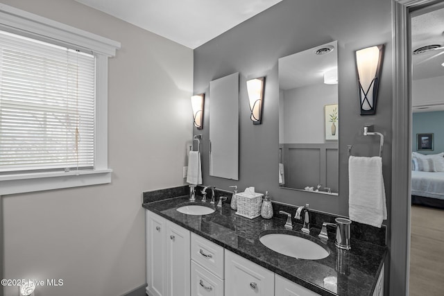 bathroom featuring a sink, visible vents, ensuite bath, and double vanity